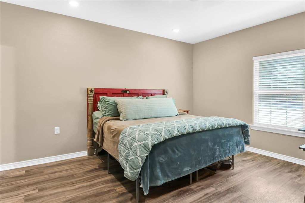 411 Johnson Street Longview, TX 75602 - Photo 24 of 25 a bedroom with a bed and a window