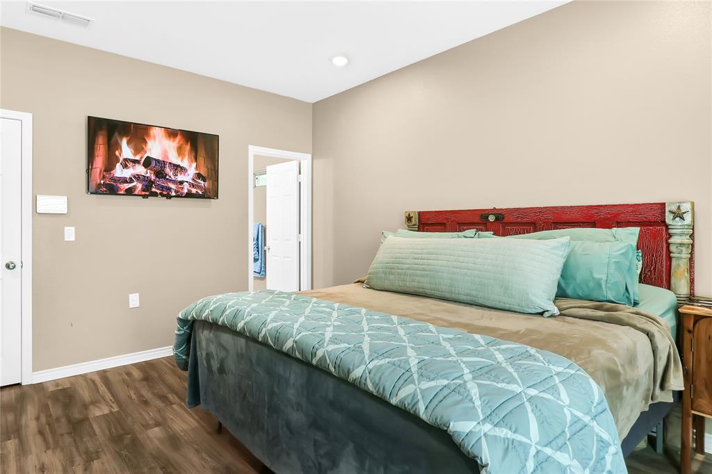 411 Johnson Street Longview, TX 75602 - Photo 25 of 25 a bedroom with a bed and a painting on the wall