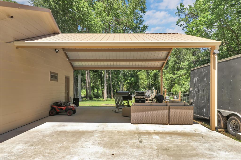 411 Johnson Street Longview, TX 75602 - Photo 5 of 25 a view of a patio with a table and chairs under an umbrella with a tub