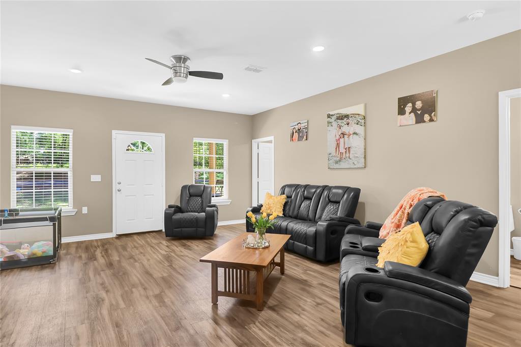 411 Johnson Street Longview, TX 75602 - Photo 9 of 25 a living room with furniture and wooden floor