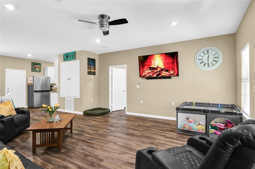 411 Johnson Street Longview, TX 75602 - Photo 10 of 25 a living room with furniture and a flat screen tv