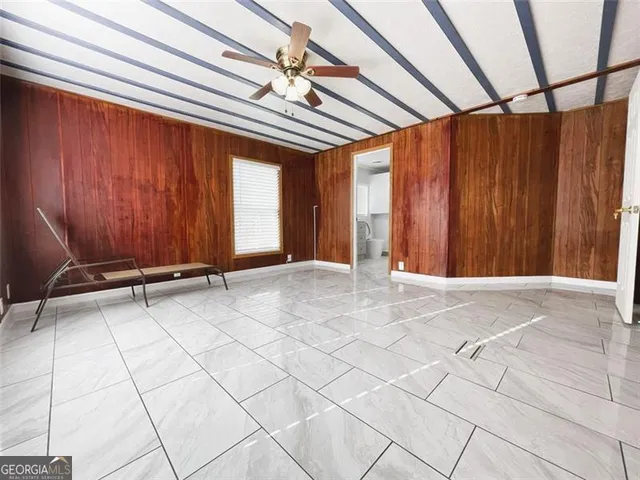 a view of bathroom with bathtub and white walls