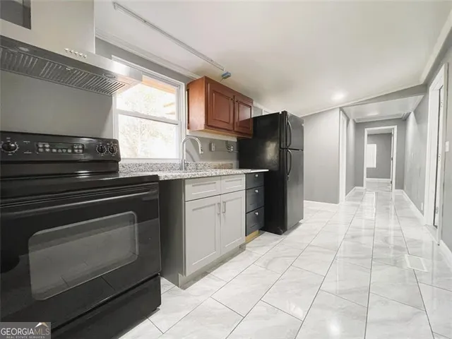 a kitchen with stainless steel appliances granite countertop a refrigerator and a sink