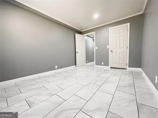 a view of a house with a wooden fence