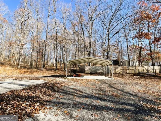 a view of large house with a yard and covered with snow