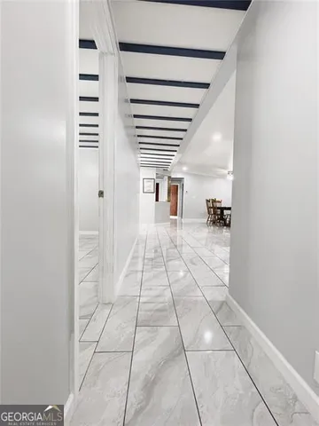 a hallway with a black white checkered floor