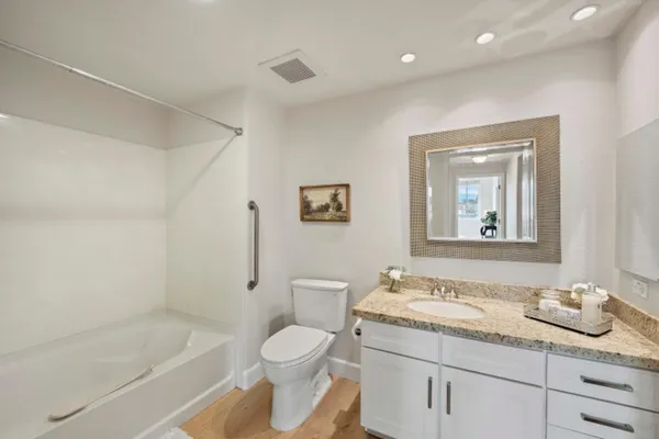 a white bath tub sitting next to a shower