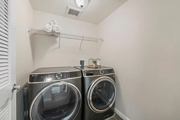 a bedroom with a bed table chair and a window