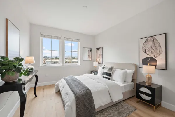 a bedroom with a bed and a painting