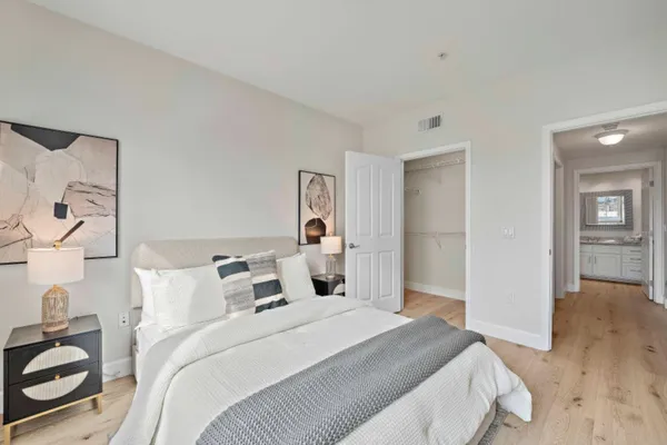 a bedroom with a bed and a chair