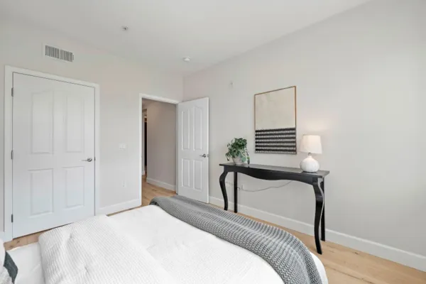 a bedroom that has a bed and a chair in it