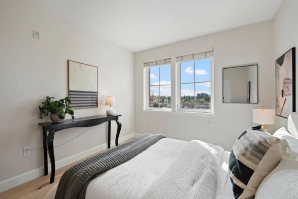 a bedroom with a bed and wooden floor