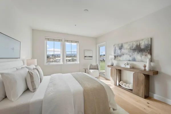 a bedroom with a bed and chandelier