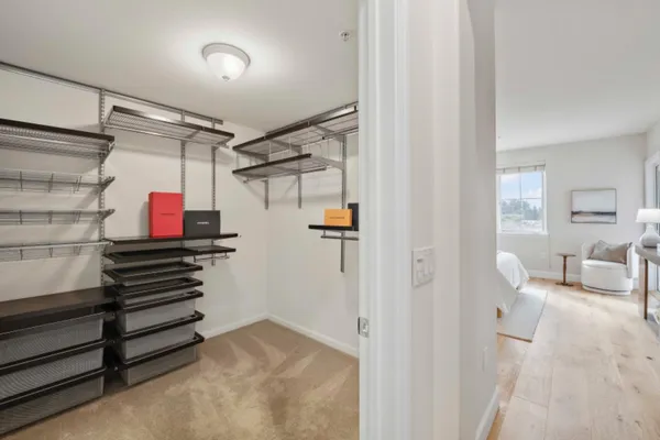 a bathroom with a double vanity sink and mirror with toilet