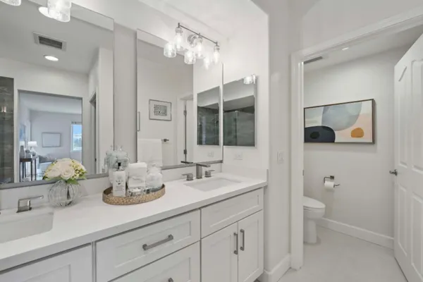 a bathroom with a granite countertop sink mirror and double