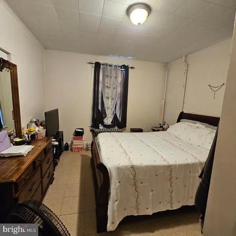 a bed room with a bed and a television