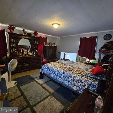 a bedroom with furniture and a mirror