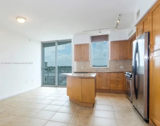 a kitchen with a sink a counter top space and cabinets