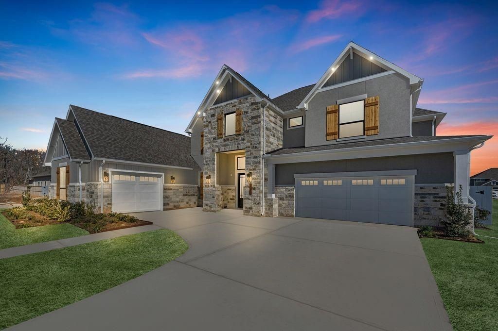 7703 Sparkle Dunn Court Fulshear, TX 77441 - Photo 2 of 20 a front view of a house with a yard and garage