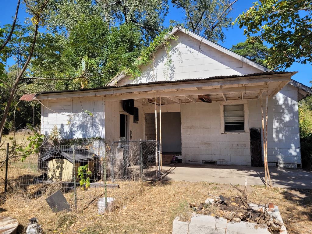 909 Ivan Road Waco, TX 76706 - Photo 2 of 10 Exterior featuring a covered porch with a corrugated metal roof and exposed wood framing