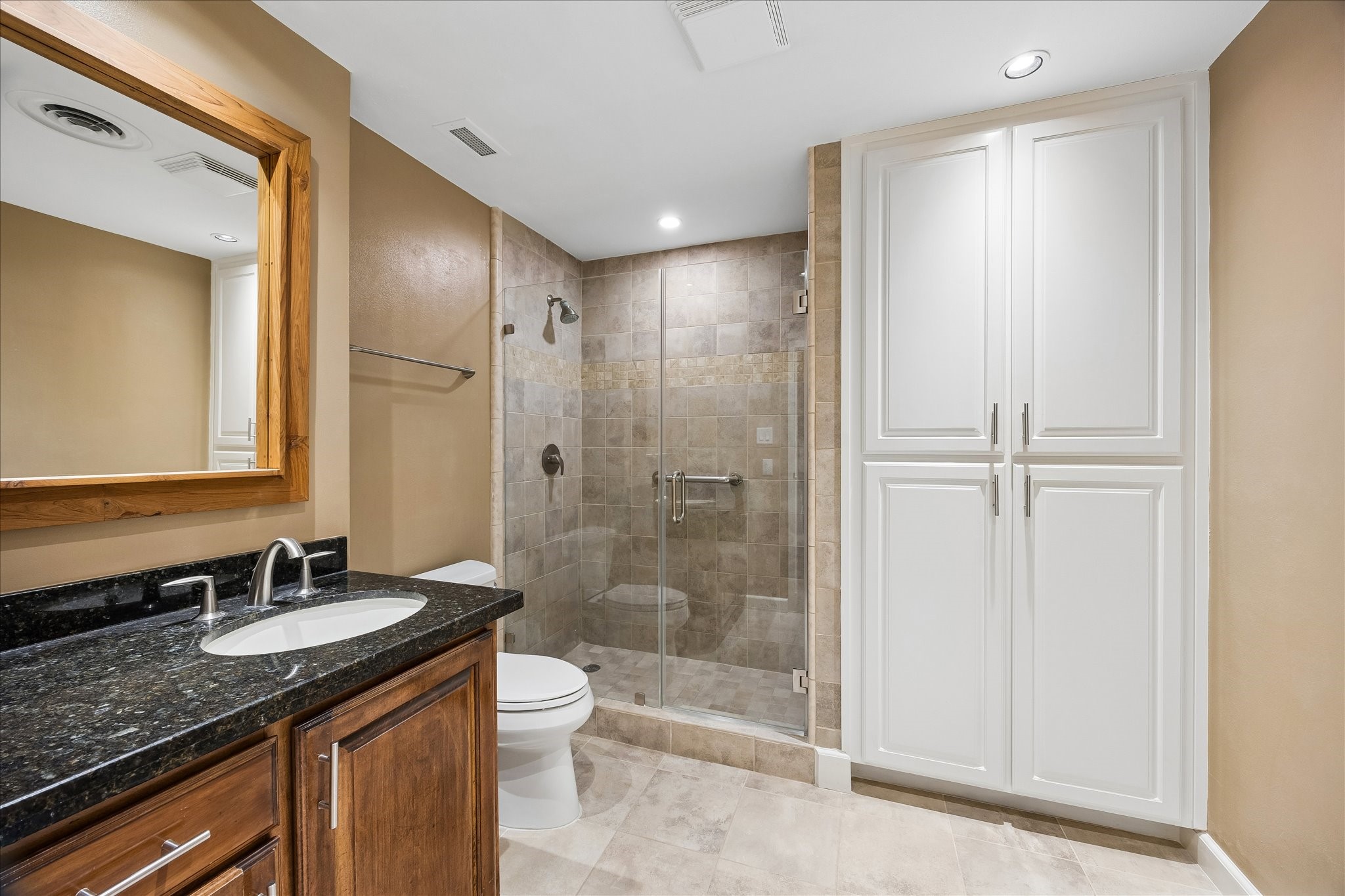 2929 Buffalo Speedway, Unit A513 Houston, TX 77098 - Photo 11 of 24 a bathroom with a granite countertop sink toilet and shower
