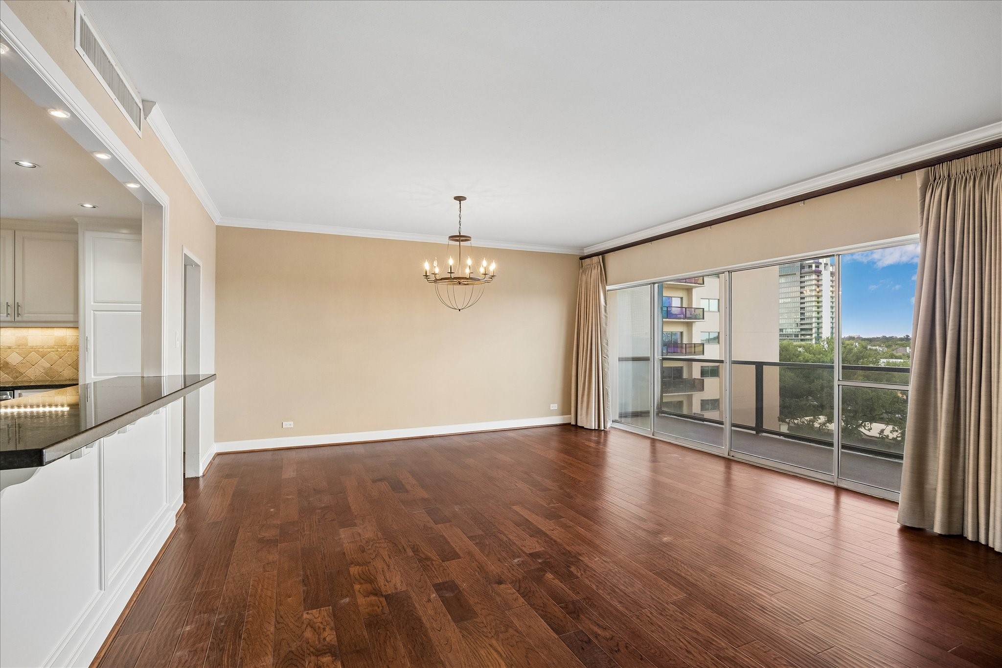 2929 Buffalo Speedway, Unit A513 Houston, TX 77098 - Photo 2 of 24 an empty room with wooden floor and windows