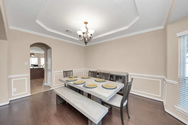a view of a dining room with furniture and wooden floor