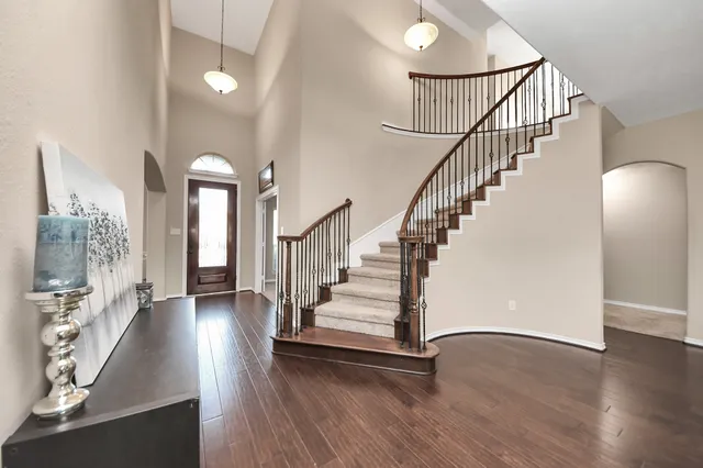 a view of entryway and hall with wooden floor