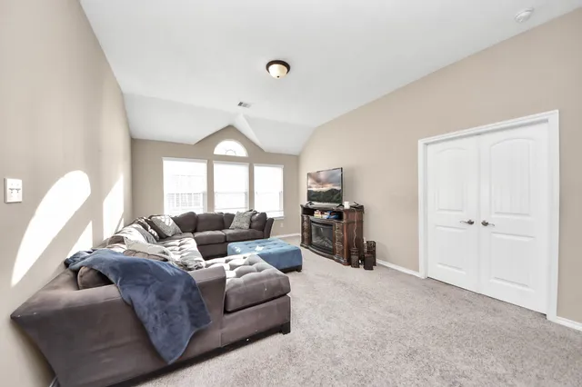 a living room with furniture and a large window