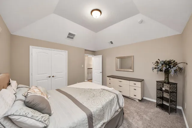 a bedroom with a bed and a potted plant