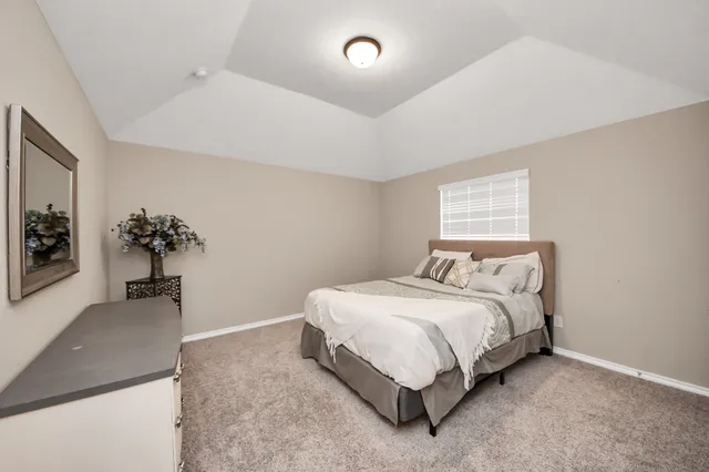 a bedroom with a bed and a potted plant