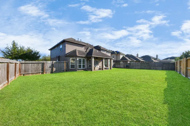 a front view of a house with yard and green space