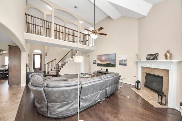 a living room with furniture a fireplace and a chandelier