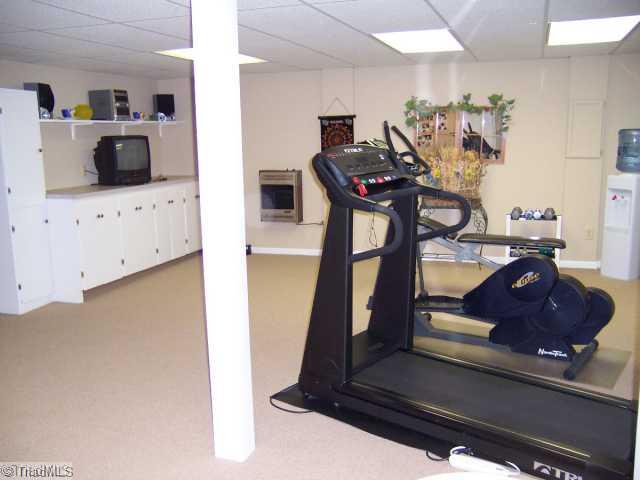 423 Kyle Road Winston-Salem, NC 27104 - Photo 12 of 16 Exercise. Spacious work-out room! Built in cabinets too! 1/2 bath / plenty of storage/ basement garage with a work-shop too!< Come and check this home out it has too many amenities to list! You will be pleasantly surprised!