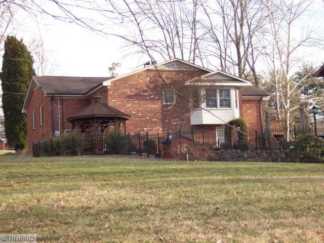 423 Kyle Road Winston-Salem, NC 27104 - Photo 15 of 16 Exterior Back. This yard has it all! Gazebo in a lovely garden surrounded by a wrought iron fence! Beautiful landscaping too! Covered Tech Gas grill with lights for grilling in the evenings! Check out the bay window too! More low care brick exterior too!