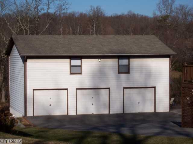 423 Kyle Road Winston-Salem, NC 27104 - Photo 16 of 16 Parking Lot/Garage. Unbelievable 3 car garage with Peg board on walls /extensive shelving for your collectables. Easy clean floor/gas heat/huge workbench/wired/1/2 bath/telephone/ac window unit. Full stairs leading up to 1200 more sq. footage , floored with more shelving..