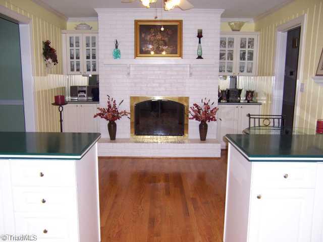 423 Kyle Road Winston-Salem, NC 27104 - Photo 3 of 16 Kitchen. Eat in Kitchen with natural gas log fireplace. More built in cabinets and beautiful original solid wood hardwood floors!