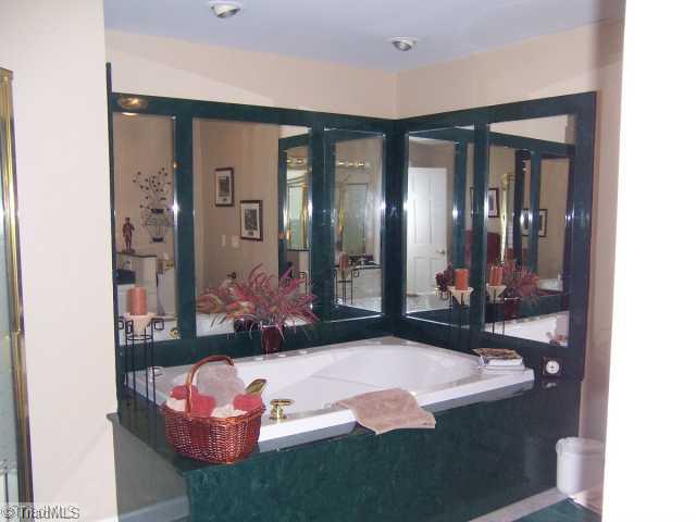 423 Kyle Road Winston-Salem, NC 27104 - Photo 8 of 16 Master Bath/Spa. Spacious and lovely bath with cultured marble finishes surrounding this jetted tub with built in bath heater. Take a warm bath for as long as you might want to relax. Walk in shower, and double sinks with a lovely floor too!