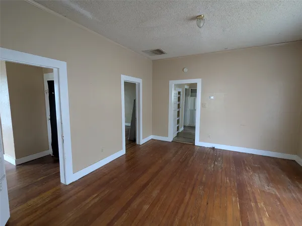 an empty room with wooden floor and closet