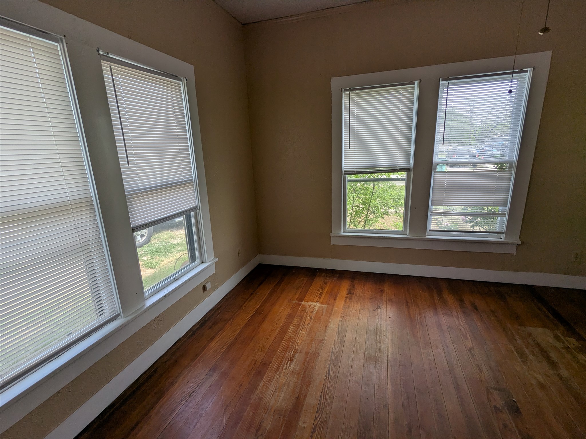 301 Park Street Taylor, TX 76574 - Photo 6 of 13 a view of an empty room with wooden floor and a window