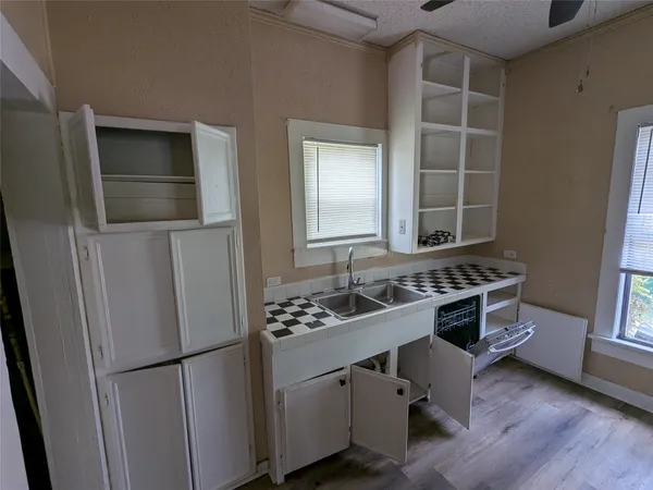 a room with cabinets and wooden floor