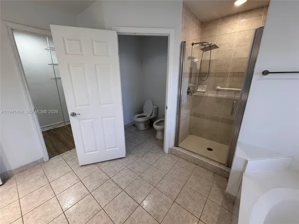 a bathroom with a glass door shower