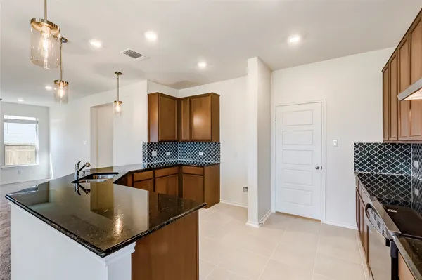 a kitchen that has a sink a microwave and a stove