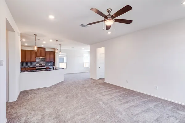 a view of a kitchen with a stove and a ceiling fan