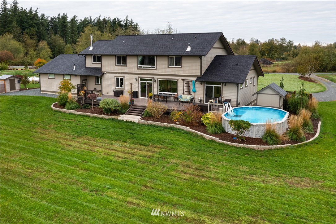 1970 East Hemmi Road Everson, WA 98247 - Photo 4 of 40 a view of a house with a backyard and swimming pool