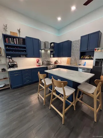 a kitchen with a cabinets and chairs
