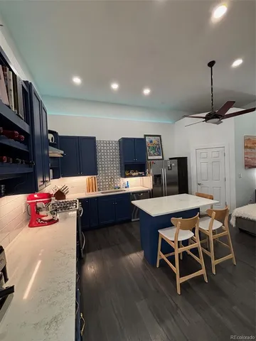 a kitchen with a table chairs refrigerator and cabinets