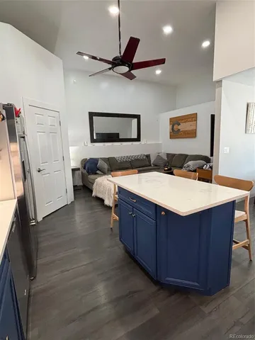 a kitchen with stainless steel appliances granite countertop a sink counter space and wooden floor