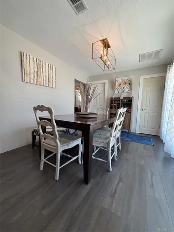 a dining room with furniture and wooden floor