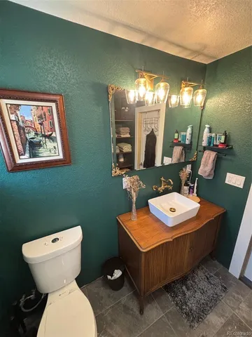 a bathroom with a toilet a sink and a mirror
